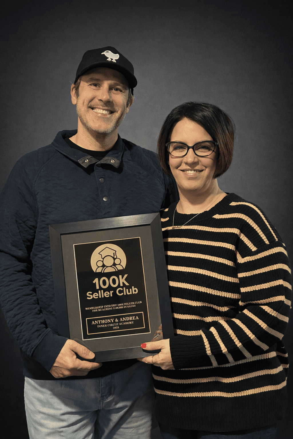 Anthony and Andrea holding their Inner Circle Academy 100K Seller Club plaque
