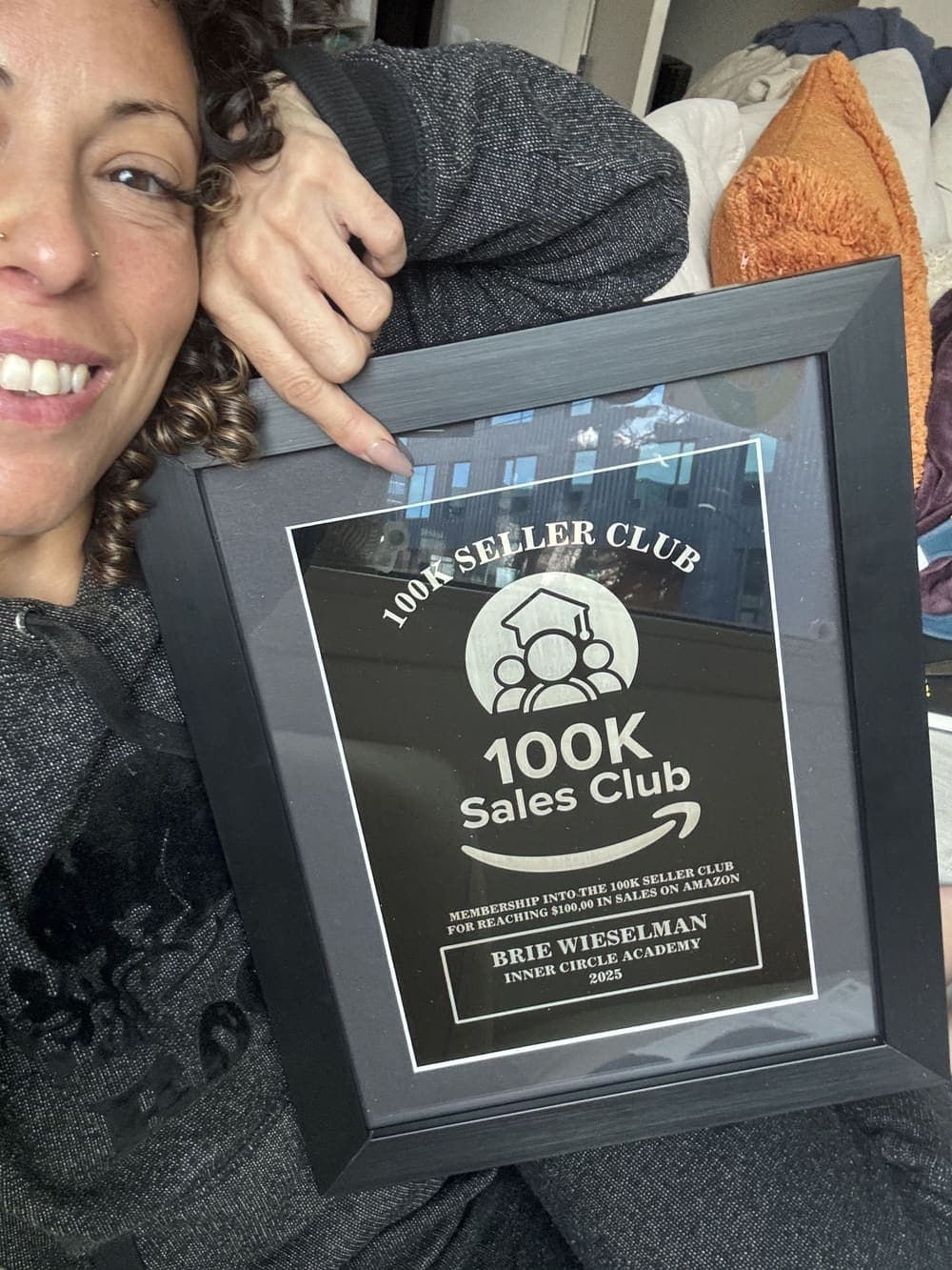 Brie Wieselman holding her Inner Circle Academy 100K Sales Club plaque